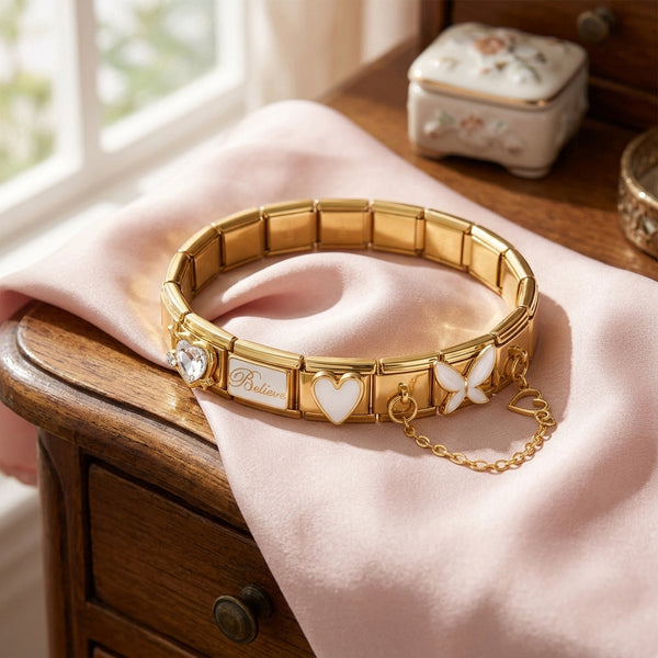 9mm Italian Charm Gold bracelet with white heart and butterfly charms on a wooden surface