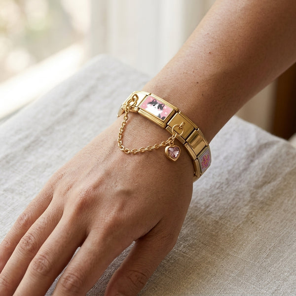Gold 9mm Italian charm bracelet with crystal heart accent chain on a wrist against a neutral background