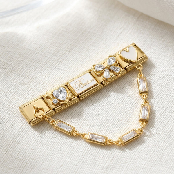 Gold 9mm Italian charm bracelet with decorative crystal charms on a light fabric background