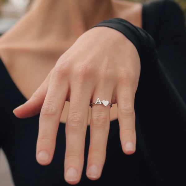 Womans Hand Showing Silver Rings With Letter A And A Heart