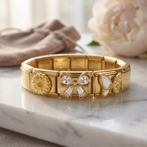 Gold 9mm Italian charm bracelet with decorative crystal and enamel elements on a marble surface
