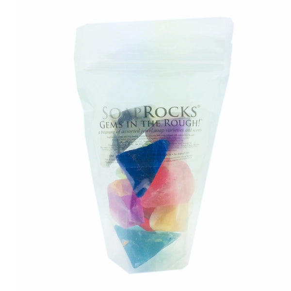 Bag of colorful soap rocks with 'Soap Rocks' gems in the rough branding on a white background