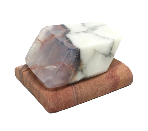 Natural sandstone soap dish with drainage holes, shown with marble soap rock, designed to keep soap dry and prevent mush. 