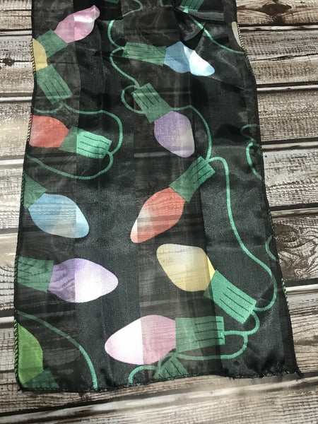 Close-up of Christmas themed chiffon scarf with colorful string light bulbs