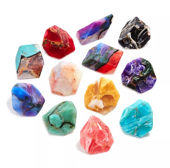 Assorted colorful soap that looks like real gemstones on white background